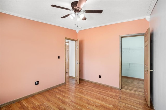 unfurnished bedroom with light wood-style flooring, baseboards, and ornamental molding