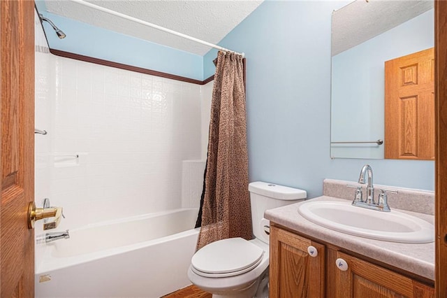 full bathroom featuring a textured ceiling, shower / bath combination with curtain, vanity, and toilet