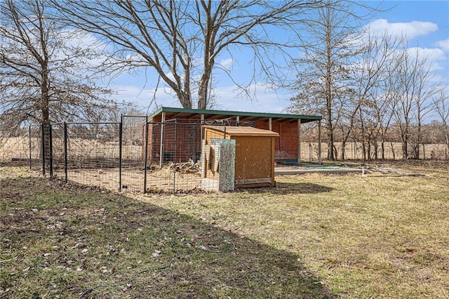 view of outbuilding featuring an outdoor structure and fence