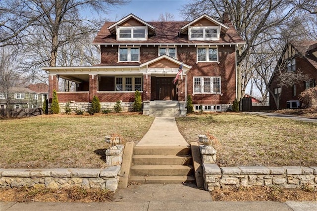 view of front of property with a front yard, brick siding, and central AC unit