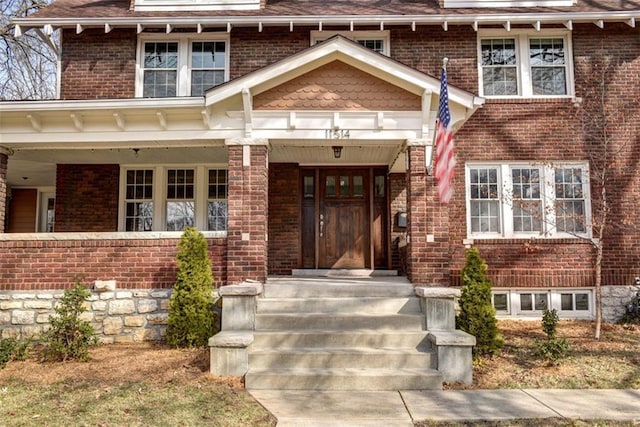 doorway to property with brick siding