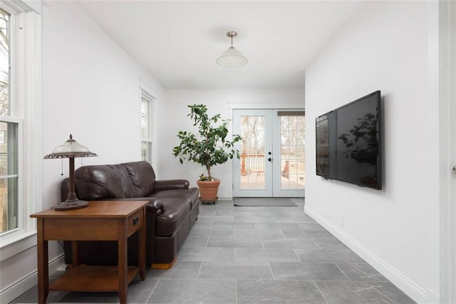 sitting room with french doors and baseboards