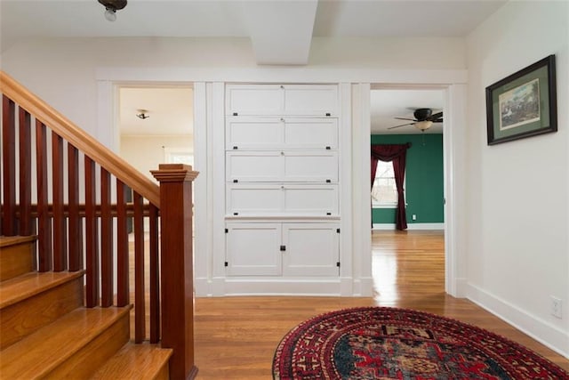 interior space with baseboards and wood finished floors