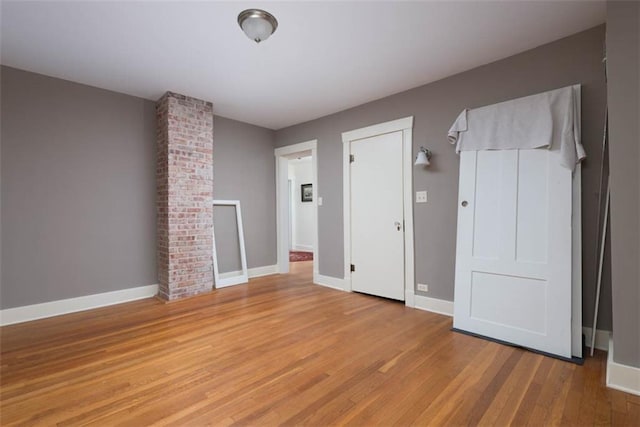 unfurnished bedroom featuring baseboards and light wood-style floors