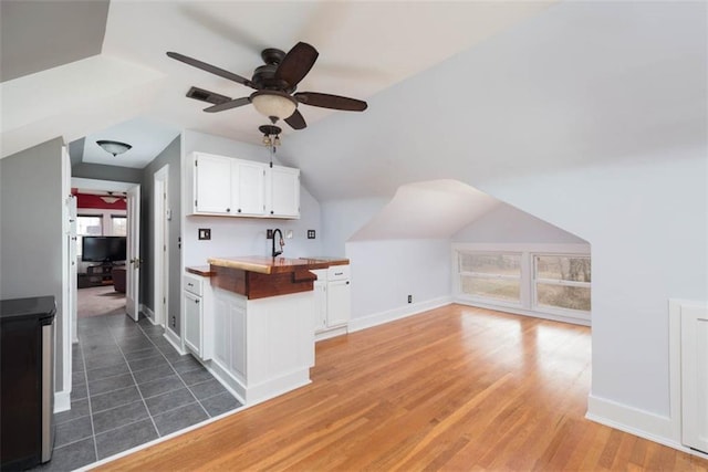 bonus room with light wood finished floors, visible vents, baseboards, a ceiling fan, and vaulted ceiling