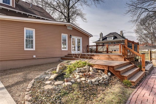 deck with french doors and fence