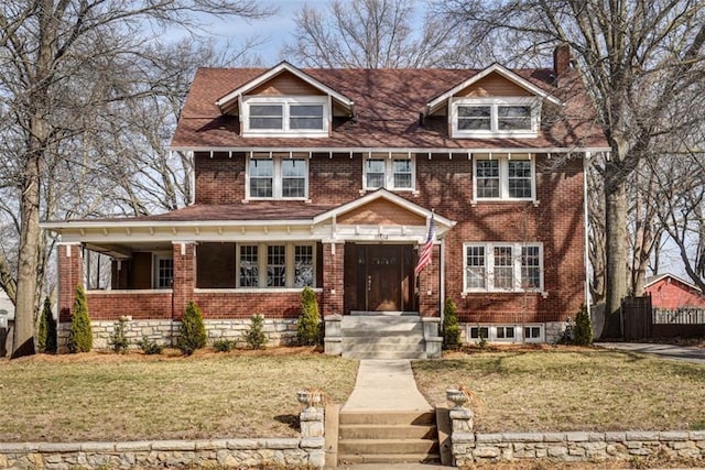 view of front of property with brick siding and a front lawn