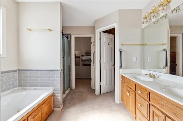 full bathroom featuring double vanity, a sink, a shower stall, and a whirlpool tub