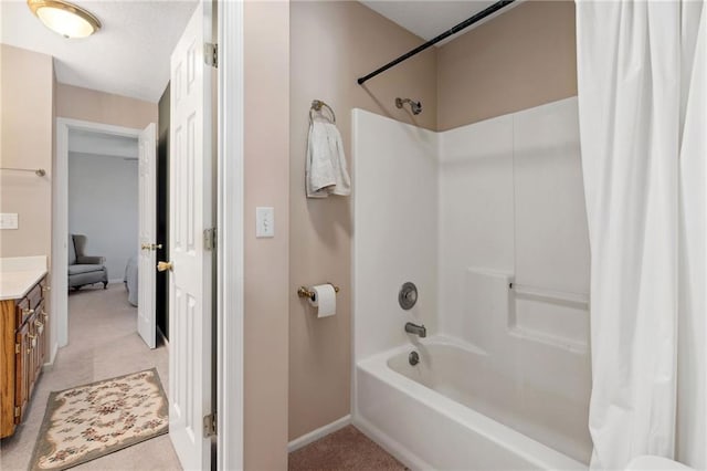 bathroom featuring vanity, shower / bath combo with shower curtain, and baseboards