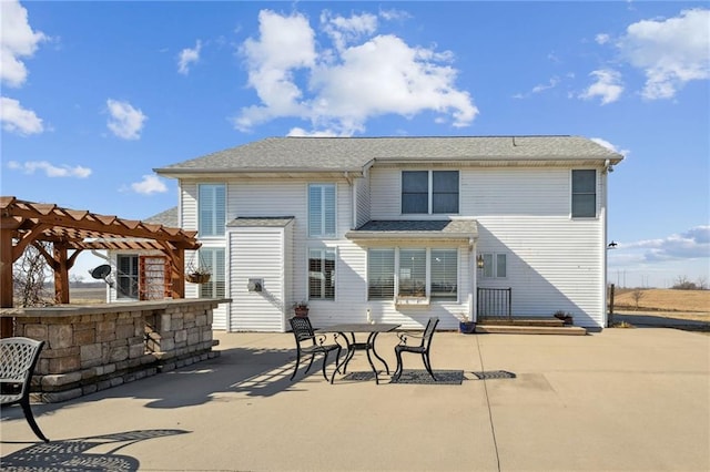 rear view of property with a patio and a pergola