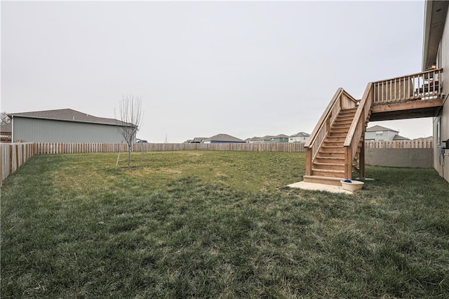 view of yard featuring stairs and a fenced backyard