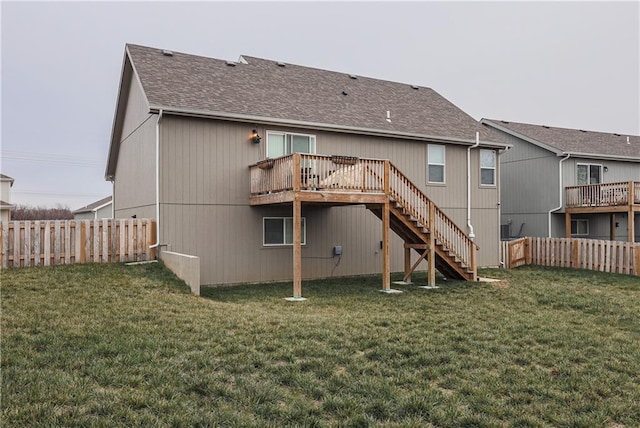 rear view of house with a yard, a fenced backyard, and stairway