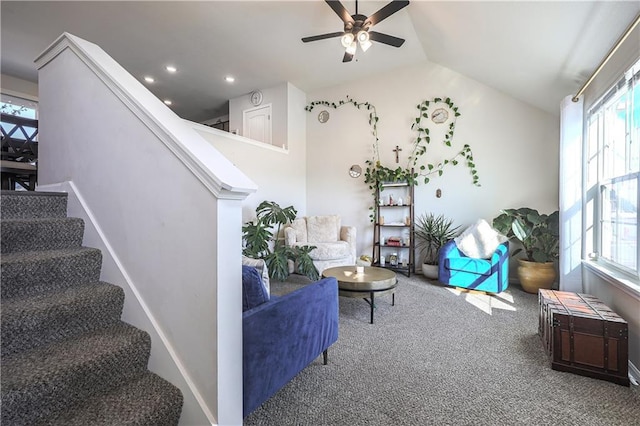 living area featuring carpet flooring, lofted ceiling, a healthy amount of sunlight, and stairs