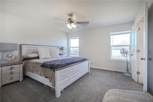 bedroom featuring baseboards, dark colored carpet, and ceiling fan