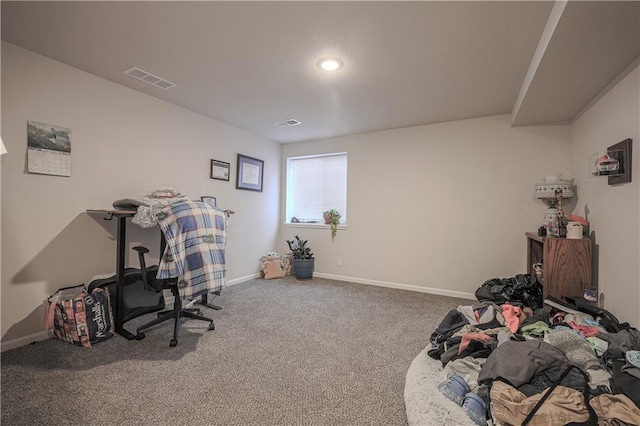 carpeted office space with visible vents and baseboards