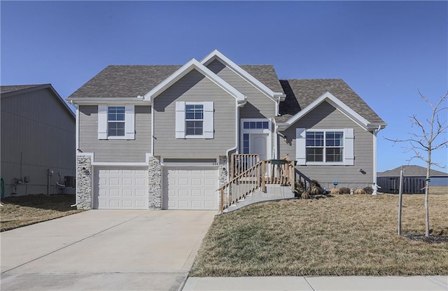 view of front facade featuring an attached garage, a front lawn, cooling unit, stone siding, and driveway