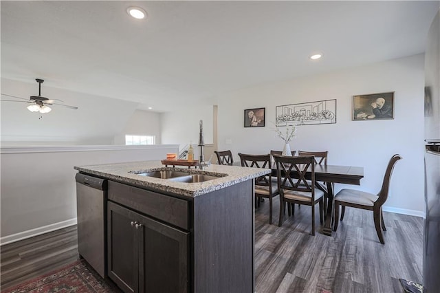 kitchen with baseboards, an island with sink, dark wood-style flooring, a sink, and dishwasher