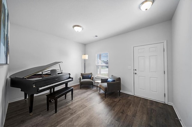 living area featuring baseboards and wood finished floors