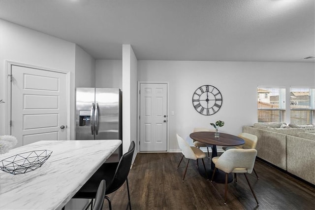 dining area featuring dark wood-style floors