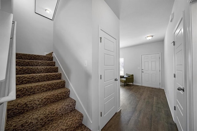 stairs featuring baseboards and wood finished floors