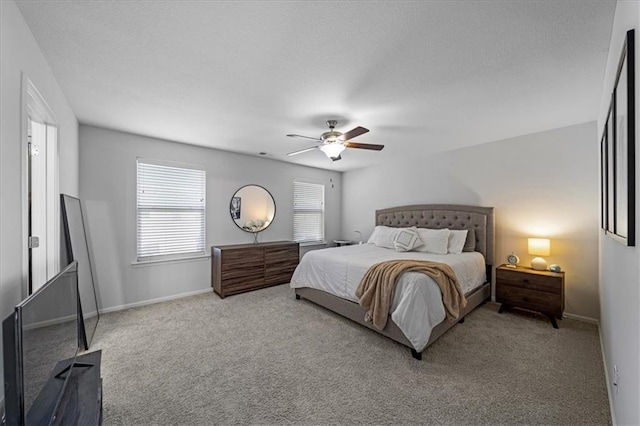 bedroom with carpet, baseboards, and a ceiling fan