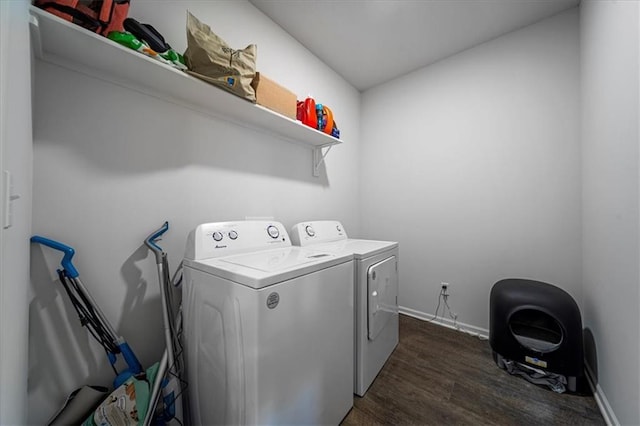 washroom featuring washer and dryer, laundry area, baseboards, and dark wood-style flooring