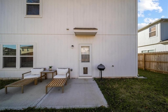 doorway to property featuring a patio area and fence