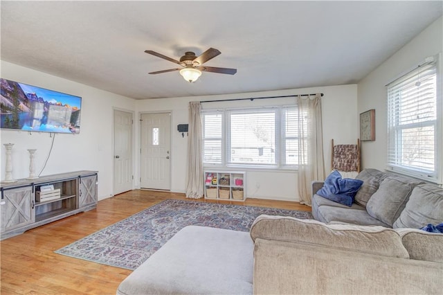 living room with ceiling fan and wood finished floors