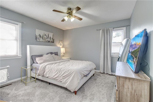 bedroom with carpet, a ceiling fan, and baseboards