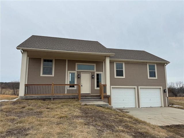 view of front of house with driveway, a porch, an attached garage, and a shingled roof