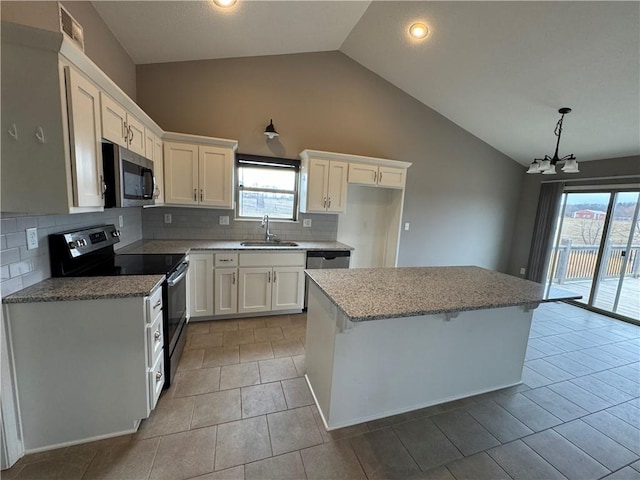 kitchen with a center island, visible vents, appliances with stainless steel finishes, white cabinetry, and a sink