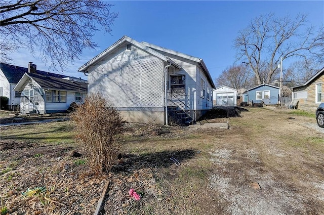 view of side of home featuring driveway and a garage