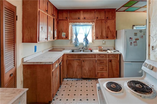 kitchen featuring white appliances, brown cabinetry, light floors, and light countertops