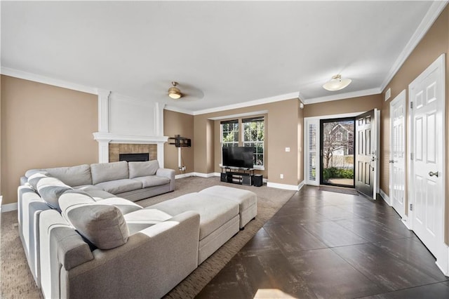 living room featuring a fireplace, baseboards, and ornamental molding