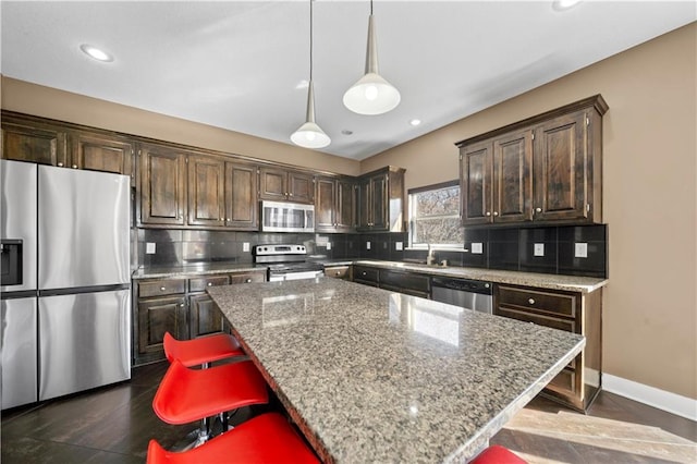 kitchen featuring stainless steel appliances, dark brown cabinets, and decorative backsplash