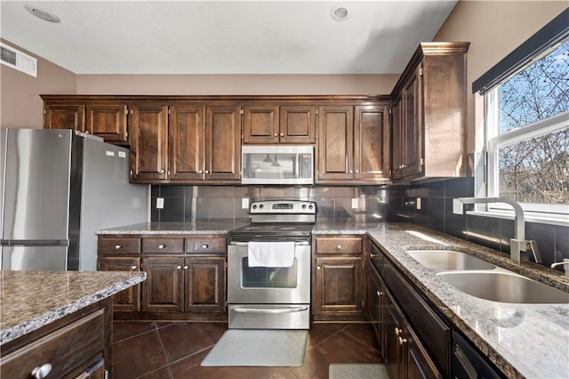 kitchen featuring a sink, tasteful backsplash, visible vents, and stainless steel appliances