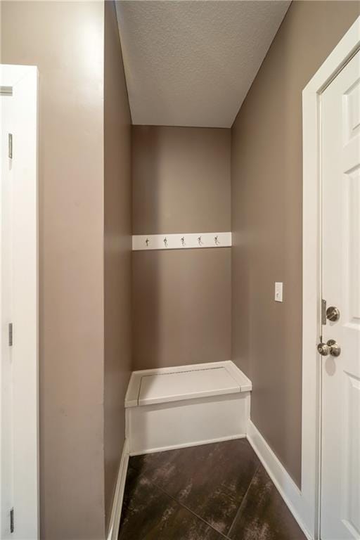 mudroom with baseboards and a textured ceiling