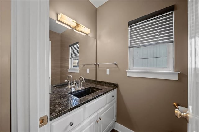 bathroom featuring vanity and baseboards