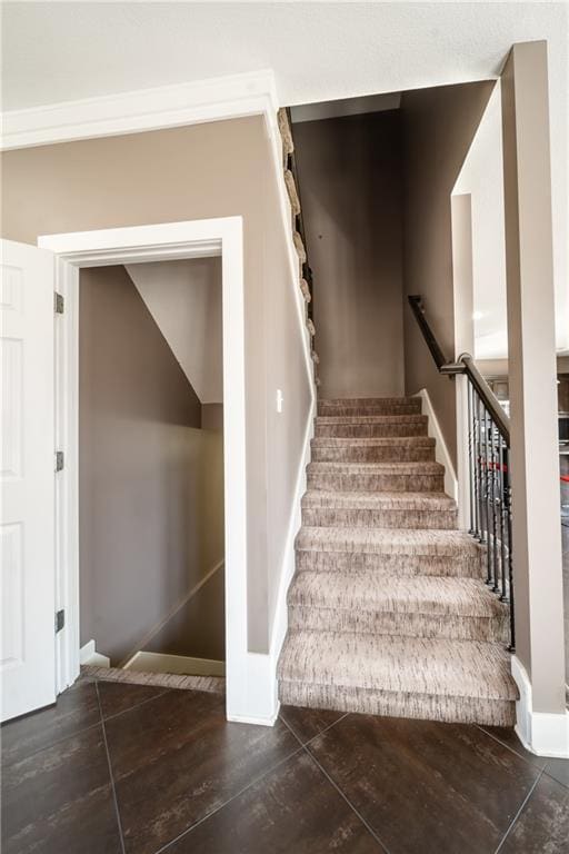 stairway featuring baseboards