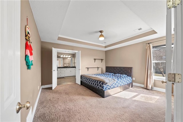 bedroom featuring visible vents, baseboards, a raised ceiling, and carpet