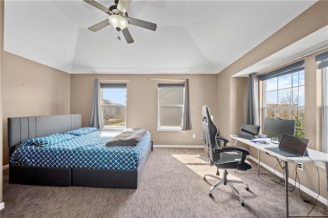 carpeted bedroom featuring baseboards, lofted ceiling, and ceiling fan