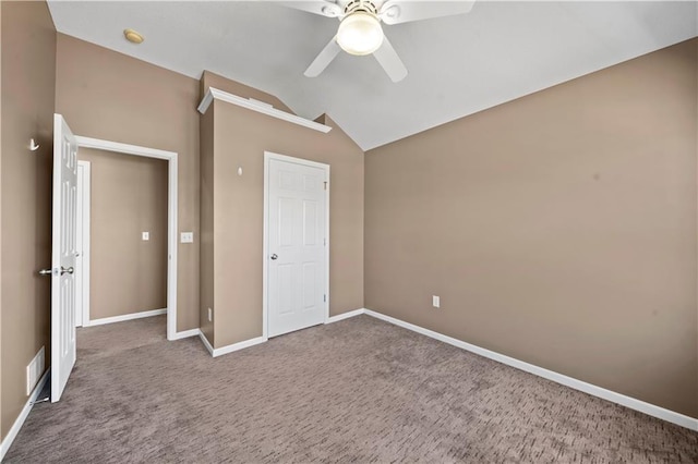 unfurnished bedroom featuring visible vents, baseboards, carpet floors, ceiling fan, and vaulted ceiling