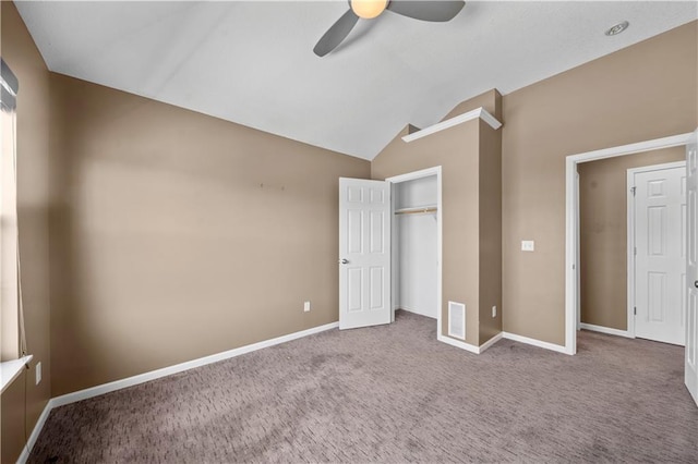 unfurnished bedroom featuring vaulted ceiling, visible vents, baseboards, and carpet floors