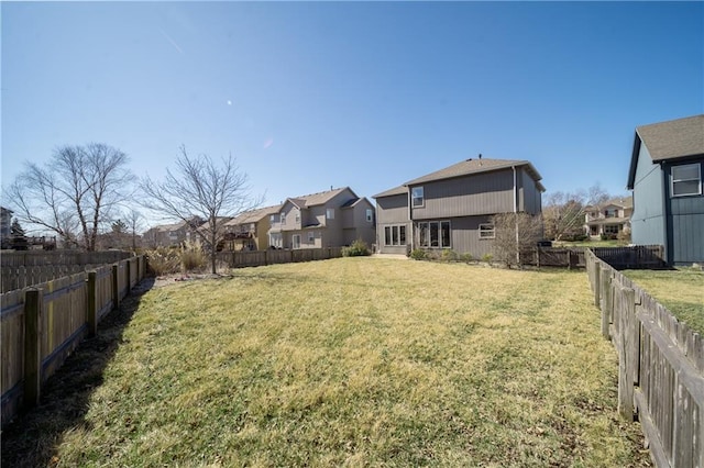 view of yard featuring a residential view and a fenced backyard