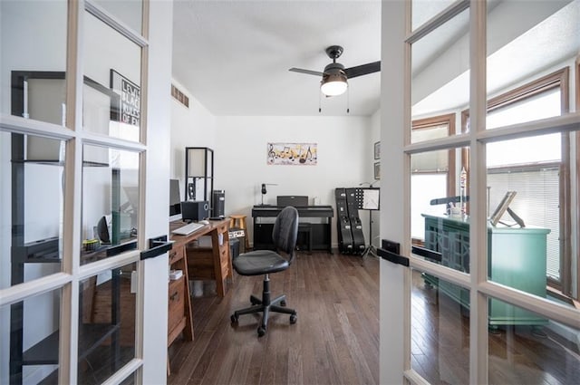 office featuring wood finished floors, visible vents, and a ceiling fan