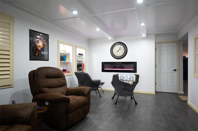 sitting room with dark wood finished floors, recessed lighting, a glass covered fireplace, beamed ceiling, and baseboards