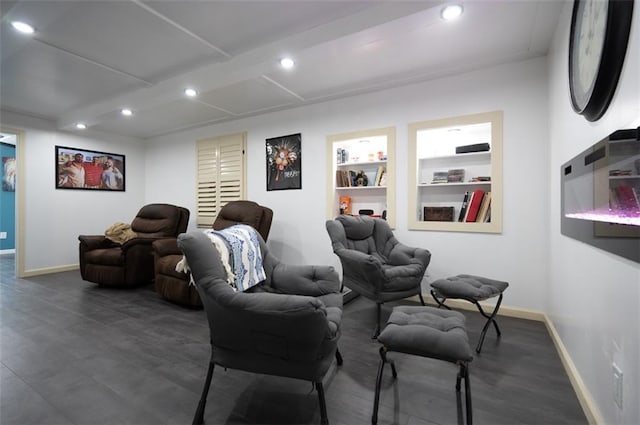 home theater room featuring built in shelves, baseboards, wood finished floors, and recessed lighting