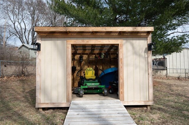 view of shed featuring fence