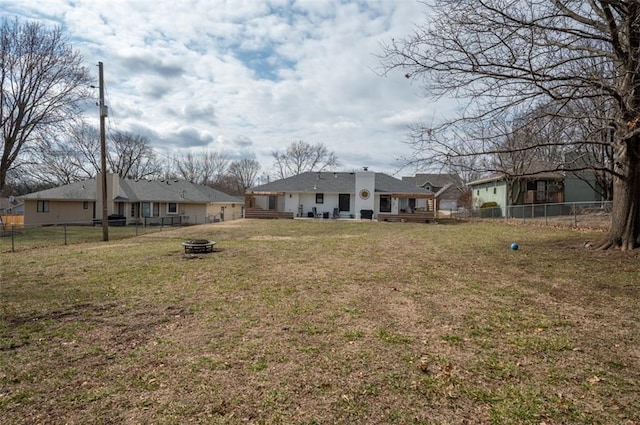 view of yard with a fire pit and a fenced backyard