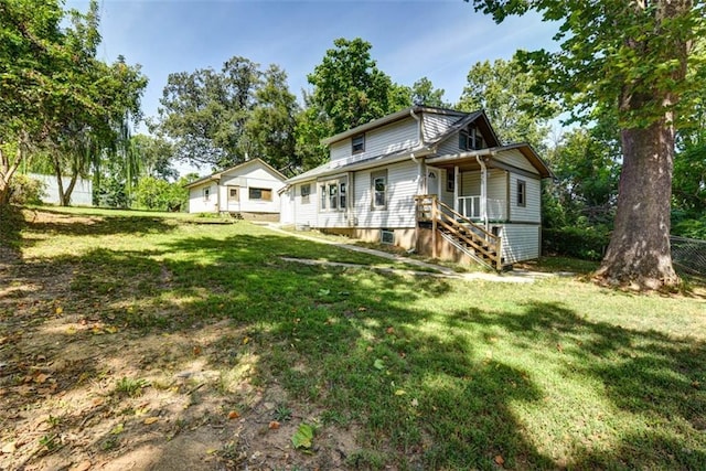 view of front of house with a front yard and fence